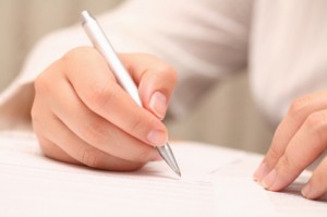 Businesswoman viewing the contract before signing