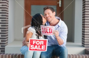 stock-photo-17808460-happy-couple-holding-for-sale-and-sold-signs-kissing